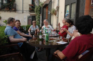 Poets gathered at tables in a cafe, Salerno, Italy, 100TPC World Conference
